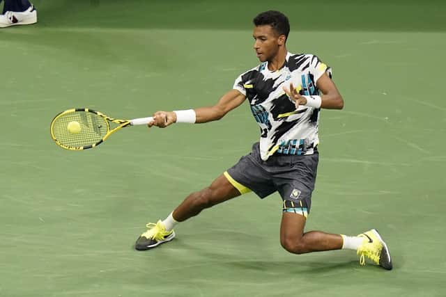 Felix Auger-Aliassime, of Canada, returns a shot to Andy Murray. (AP Photo/Frank Franklin II)