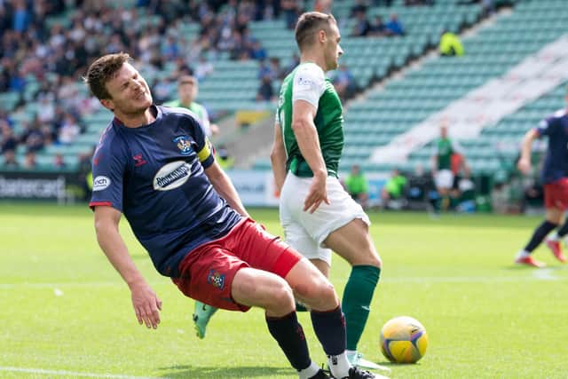 Kilmarnock captain Chris Stokes clutches his hamstring with Kyle Magennis set to strike. Referee Bobby Madden stopped play (Photo by Ross Parker / SNS Group)