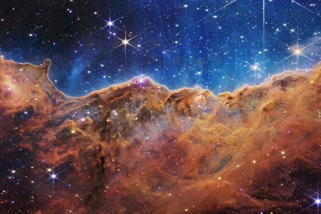 NASA image from the James Webb Space Telescope (JWST) which  shows a landscape of mountains and valleys speckled with glittering stars, which sits at the edge of a nearby, young, star-forming region called NGC 3324 in the Carina Nebula. The image was partly produced by an instrument which was largely designed and built in Scotland under the leadership of Professor Gillian Wright of the UK Astronomy Technology Centre (UK ATC)  at the Royal Observatory in Edinburgh.  Photo by HANDOUT/NASA/AFP via Getty Images)
