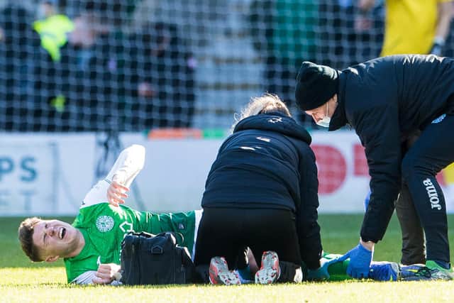 Kevin Nisbet receives treatment for a knee injury during the 0-0 draw with Celtic at Easter Road on Sunday. (Photo by Ross Parker / SNS Group)