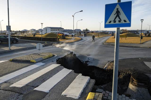 A crack cuts across the main road in Grindavik, southwestern Iceland following earthquakes. Grindavik -- home to around 4,000 people -- was evacuated last month after magma shifting under the Earth's crust caused hundreds of earthquakes.