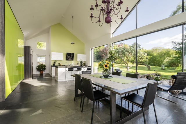 Interior: The 5,608sq ft home features an open-plan dining-kitchen area with full-height window walls, lounge with French doors, snug, study, playroom and bar. Upstairs accommodates four ensuite bedrooms.