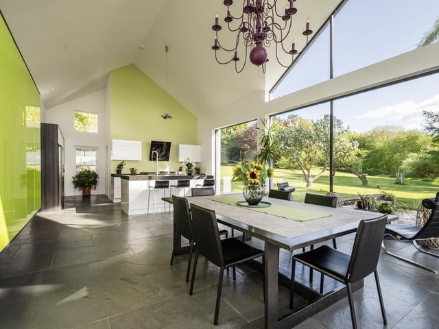Interior: The 5,608sq ft home features an open-plan dining-kitchen area with full-height window walls, lounge with French doors, snug, study, playroom and bar. Upstairs accommodates four ensuite bedrooms.