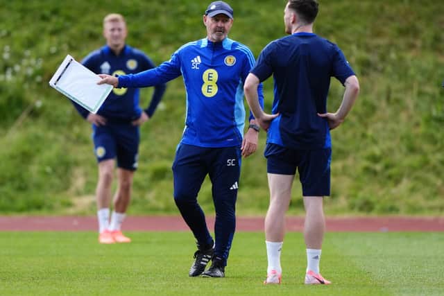 Scotland head coach Steve Clarke speaks to captain Andy Robertson during a training session at Stadion am Groben in Garmisch-Partenkirchen, Germany. Picture date: Sunday June 16, 2024.