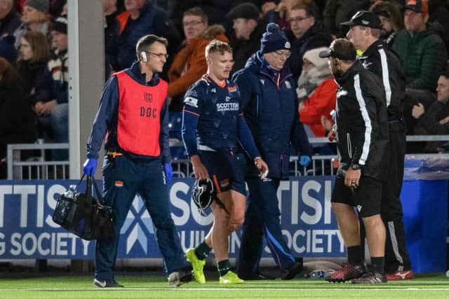Edinburgh's Darcy Graham goes off injured after hurting his knee against the Lions.