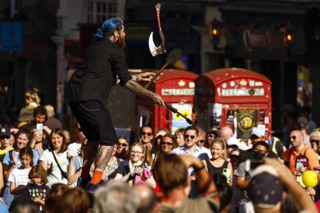 A Fringe street entertainer gathers a crowd on the Royal Mile.