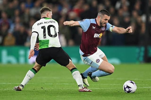 Aston Villa captain John McGinn is challenged by Liverpool midfielder Alexis Mac Allister during the 3-3 draw at Villa Park. (Photo by Shaun Botterill/Getty Images)