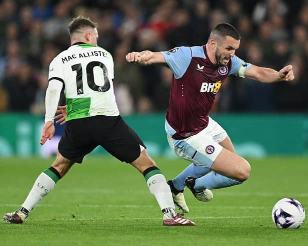 Aston Villa captain John McGinn is challenged by Liverpool midfielder Alexis Mac Allister during the 3-3 draw at Villa Park. (Photo by Shaun Botterill/Getty Images)