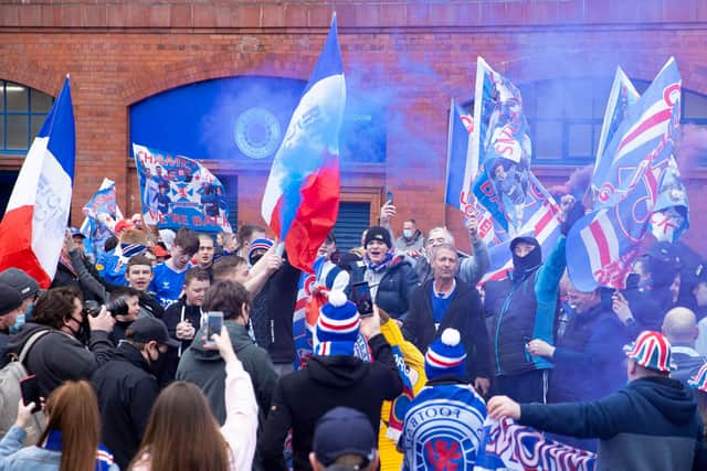 Rangers fans gather outside Ibrox to celebrate title victory. Picture: SNS