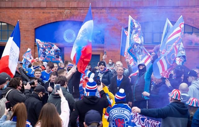 Rangers fans gather outside Ibrox to celebrate title victory. Picture: SNS