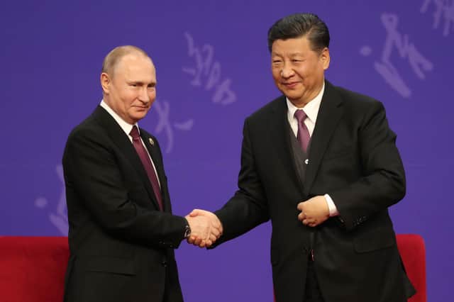 Russian President Vladimir Putin shakes hands with Chinese President Xi Jinping on a 2019 trip to Beijing (Picture: Kenzaburo Fukuhara/pool/Getty Images)