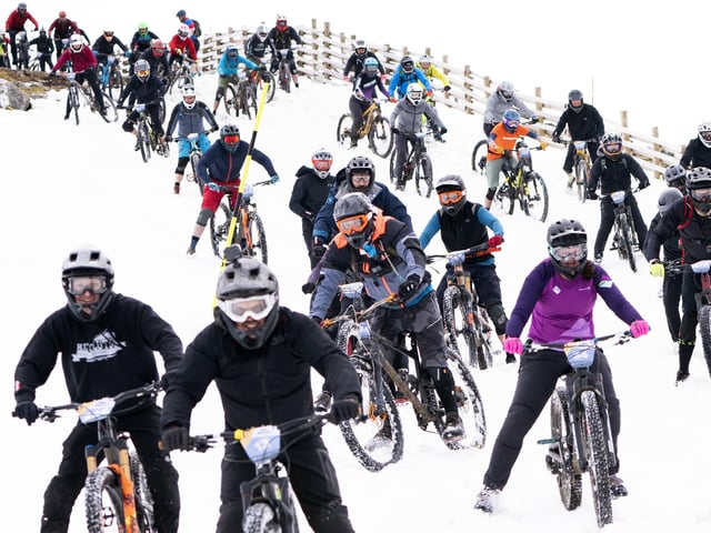Following an arduous climb up the mountain, which reaches 1,221 metres, riders started in deep snow at the beginning of the route.
: Jane Barlow/PA Wire
