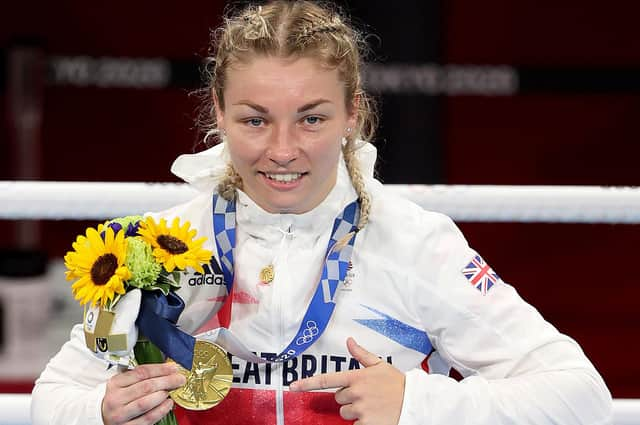 Lauren Price celebrates with her gold medal