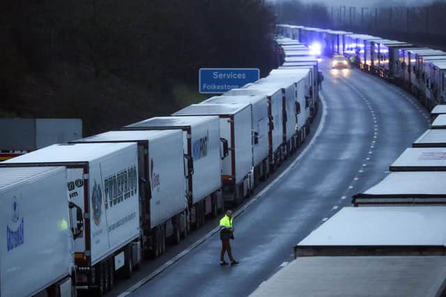 A drive sits in the cab of his lorry while parked on the M20 in Kent after the Port of Dover was closed after the French government's announcement it will not accept any passengers arriving from the UK. France appears set to end a ban on hauliers crossing the Channel which was imposed due to fears about the spread of the new coronavirus strain picture: PA