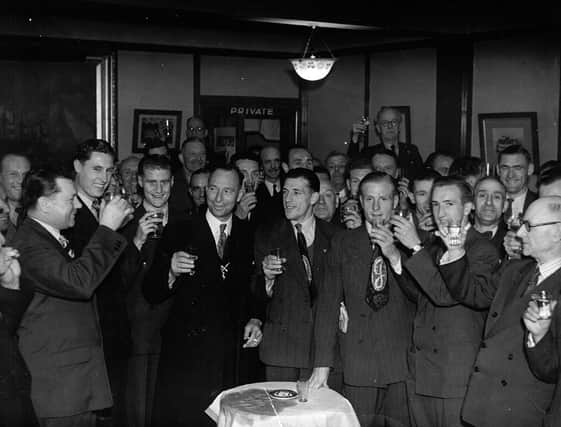 Pompey players and backroom staff celebrate the club's championship win at the end of the 1948-49 season with Tom Holland (with the moustache) in the centre at the back.