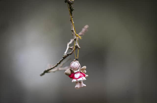 An angel figure hangs from a tree in the Garden of Remembrance at Dunblane Cemetery ahead of the 25th anniversary of the Dunblane massacre on Saturday.