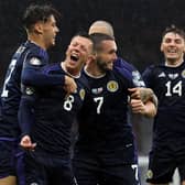The Scotland players celebrate Callum McGregor's opener - which came just before the long delay at Hampden.