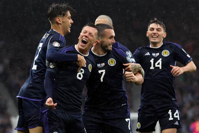 The Scotland players celebrate Callum McGregor's opener - which came just before the long delay at Hampden.