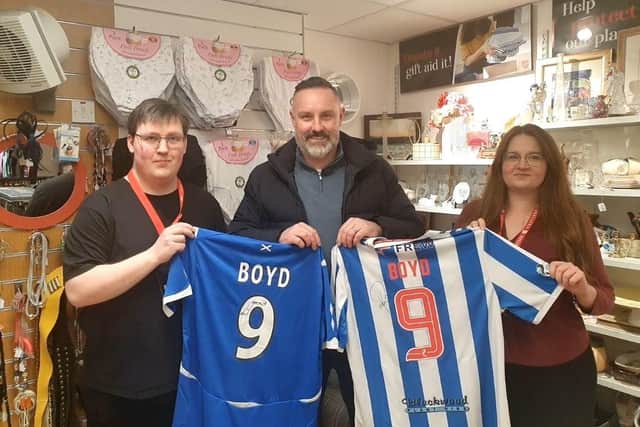 Kris Boyd donates signed shirts at a Salvation Army store in Kilmarnock.