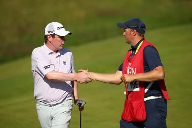 Bob MacIntyre shakes hands with his caddie Mike Thomson after tying for eighth in the 149th Open at Royal St George's Christopher Lee/Getty Images.