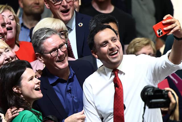 Keir Starmer and Scottish Labour leader Anas Sarwar take a selfie with supporters at an event in East Kilbride on Wednesday (Photo by Jeff J Mitchell/Getty Images)