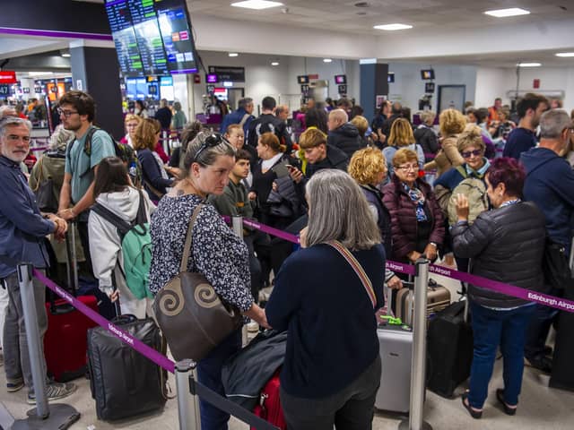Passengers at Edinburgh Airport on Tuesday. (Photo by Lisa Ferguson)