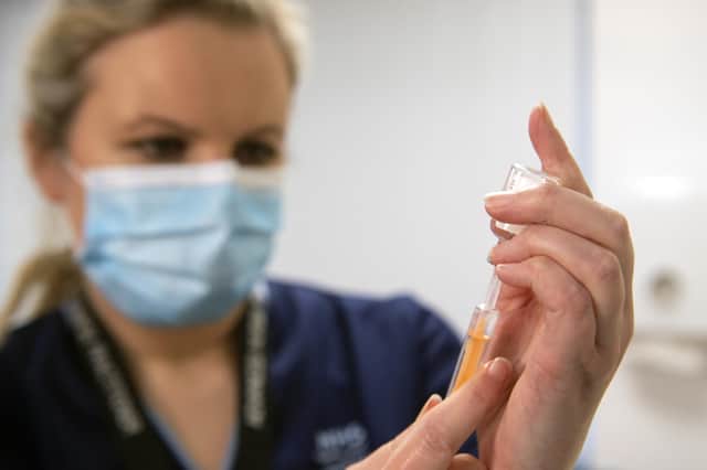 Advanced nurse practitioner Justine Williams prepares a dose of the AstraZeneca/Oxford Covid-19 vaccine at the Lochee Health Centre in Dundee.
