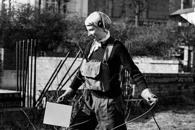 2HX4YA3 Britain's Women Learn Atom Defence -- Wearing anti-gas boots and headphones, a woman serving in HMS Phoenixs defence school demonstrates atomic defence techniques at Winchester, in England, in 1952. Picture: Associated Press Photo
