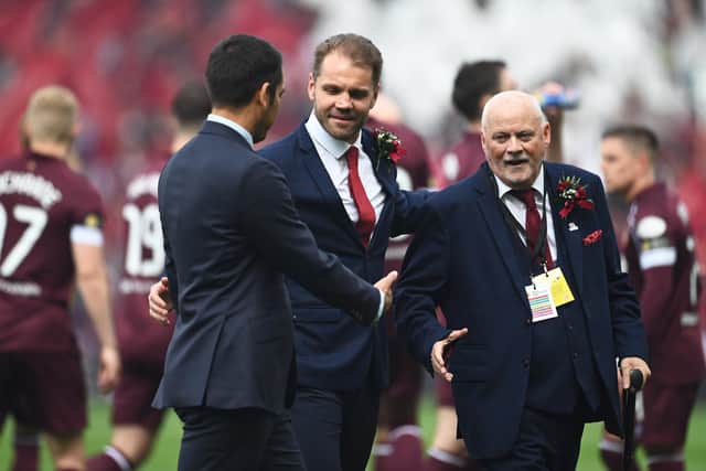 Rangers Manager Giovanni van Bronckhorst shakes hands with Robbie Neilson and Hearts supporter, Stevie Morris,  during the Scottish Cup Final match between Rangers and Hearts at Hampden Park. Paul Devlin SNS
