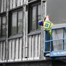 Workers remove cladding for testing from a tower block in the wake of the Grenfell Tower tragedy. Picture: Christopher Furlong/Getty Images