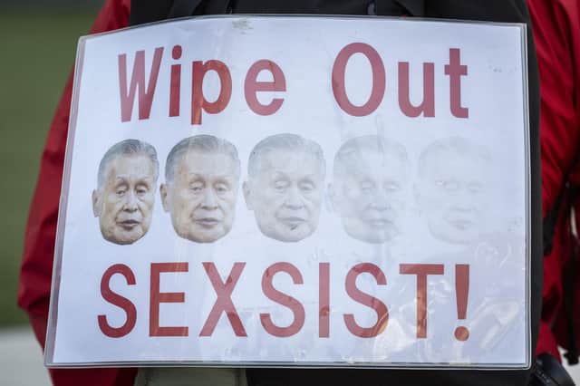 A man holds a placard with pictures of Yoshiro Mori, president of the Tokyo Olympic and Paralympic organising committee, who is expected to his resign after making sexist remarks. Picture: Yuichi Yamazaki/Getty Images