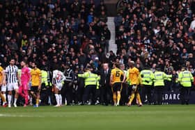 Stewards and police officers attempt to stop a pitch invasion during the Emirates FA Cup Fourth Round match between West Bromwich Albion and Wolverhampton Wanderers at The Hawthorns. (Photo by Jack Thomas - WWFC/Wolves via Getty Images)