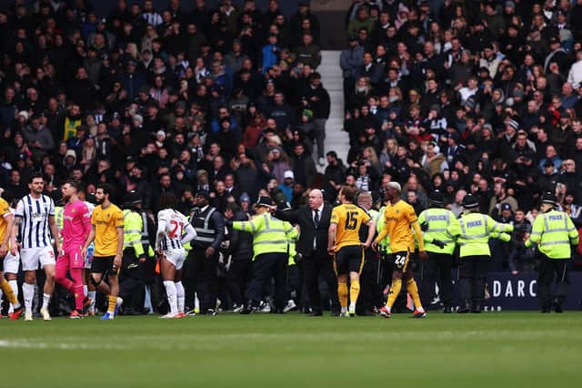 Stewards and police officers attempt to stop a pitch invasion during the Emirates FA Cup Fourth Round match between West Bromwich Albion and Wolverhampton Wanderers at The Hawthorns. (Photo by Jack Thomas - WWFC/Wolves via Getty Images)