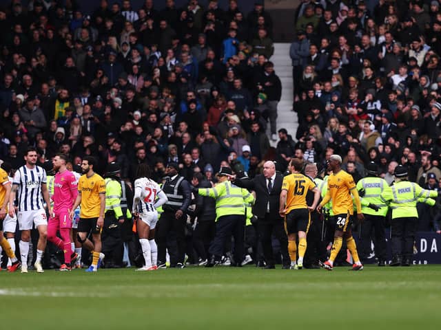 Stewards and police officers attempt to stop a pitch invasion during the Emirates FA Cup Fourth Round match between West Bromwich Albion and Wolverhampton Wanderers at The Hawthorns. (Photo by Jack Thomas - WWFC/Wolves via Getty Images)