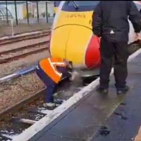 A driver clearing snow from the train horn using hot water. Picture: Doug Paulley