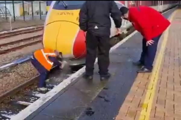 A driver clearing snow from the train horn using hot water. Picture: Doug Paulley