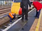 A driver clearing snow from the train horn using hot water. Picture: Doug Paulley