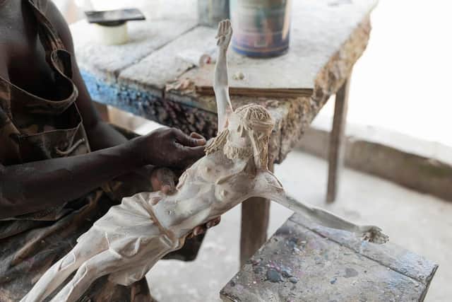Sculptor Anthony Agasi works on a figure of Jesus Christ at his workshop in Onitsha, Nigeria, the world's most dangerous country to be a Christian (Picture: Patrick Meinhardt/AFP via Getty Images)