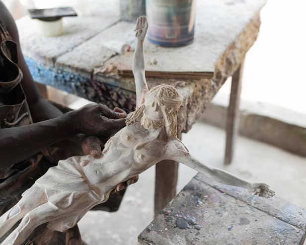 Sculptor Anthony Agasi works on a figure of Jesus Christ at his workshop in Onitsha, Nigeria, the world's most dangerous country to be a Christian (Picture: Patrick Meinhardt/AFP via Getty Images)