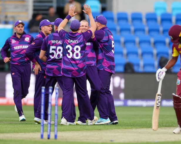 Scotlands Michael Leask (c) celebrates with teammates after dismissing West Indies captain Nicholas Pooran during the historic T20 World Cup win in Hobart. (Photo by DAVID GRAY/AFP via Getty Images)