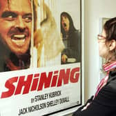 A woman looks at a display from the movie "The Shining" is seen at an exhibition of items from 13 movies of director Stanley Kubrick. (Photo by Mark Renders/Getty Images)