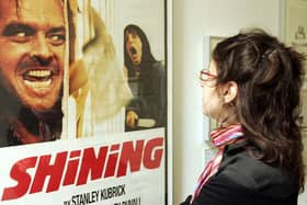 A woman looks at a display from the movie "The Shining" is seen at an exhibition of items from 13 movies of director Stanley Kubrick. (Photo by Mark Renders/Getty Images)