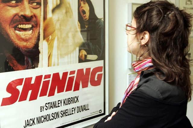 A woman looks at a display from the movie "The Shining" is seen at an exhibition of items from 13 movies of director Stanley Kubrick. (Photo by Mark Renders/Getty Images)