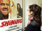 A woman looks at a display from the movie "The Shining" is seen at an exhibition of items from 13 movies of director Stanley Kubrick. (Photo by Mark Renders/Getty Images)