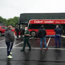 A Paramedic guides members of the public as they queue outside a covid vaccination bus at the Forge Shopping Centre in Glasgow (Photo: Andrew Milligan/PA Wire).