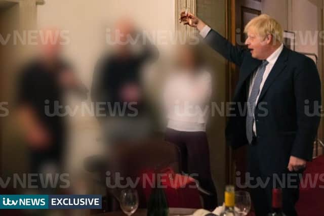 A photograph obtained by ITV News of the Prime Minister raising a glass at a leaving party on November 13, 2020, with bottles of alcohol and party food on the table in front of him. Picture: ITV/PA Wire