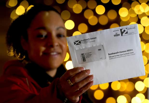 Postal worker Patrona Tunilla holds a sample Scotland's Census letter during its launch at the University of Glasgow last month. Census results are vital in guiding public policy. (Picture: Andrew Milligan/PA)