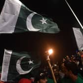People hold national flags as they gather during Independence Day celebrations in Karachi (Getty Images)