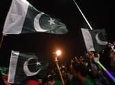 People hold national flags as they gather during Independence Day celebrations in Karachi (Getty Images)