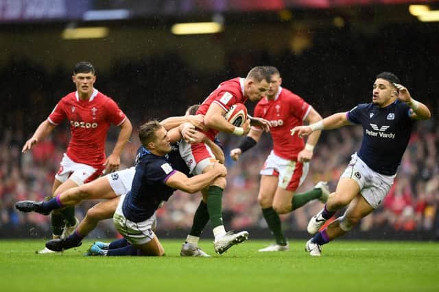 Liam Williams of Wales is tackled by Duhan van der Merwe and Chris Harris of Scotland during the Guinness Six Nations match between Wales and Scotland at Principality Stadium on February 12, 2022 in Cardiff, Wales. (Photo by Clive Mason/Getty Images)